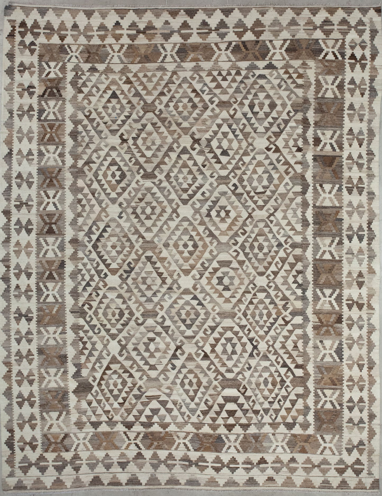 This carpet comes with beige background and a greco roman pattern in gray and brown. 