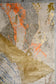 On the top right corner, there are brushes strokes in gray, and gold, plus a few details in orange.