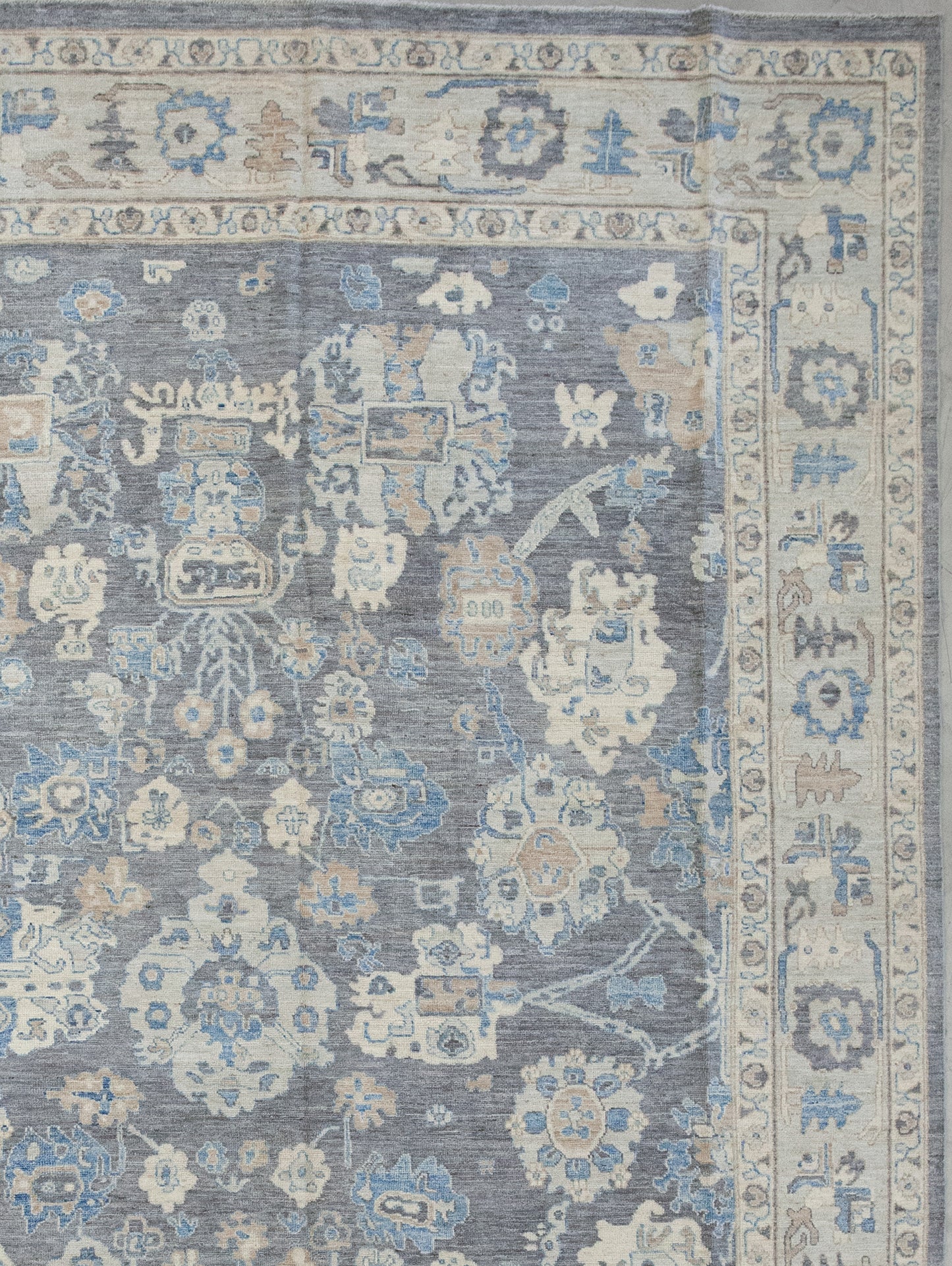 The beige borders show small flowers and blue  laces, while the beige thick frame displays abstract shapes. 