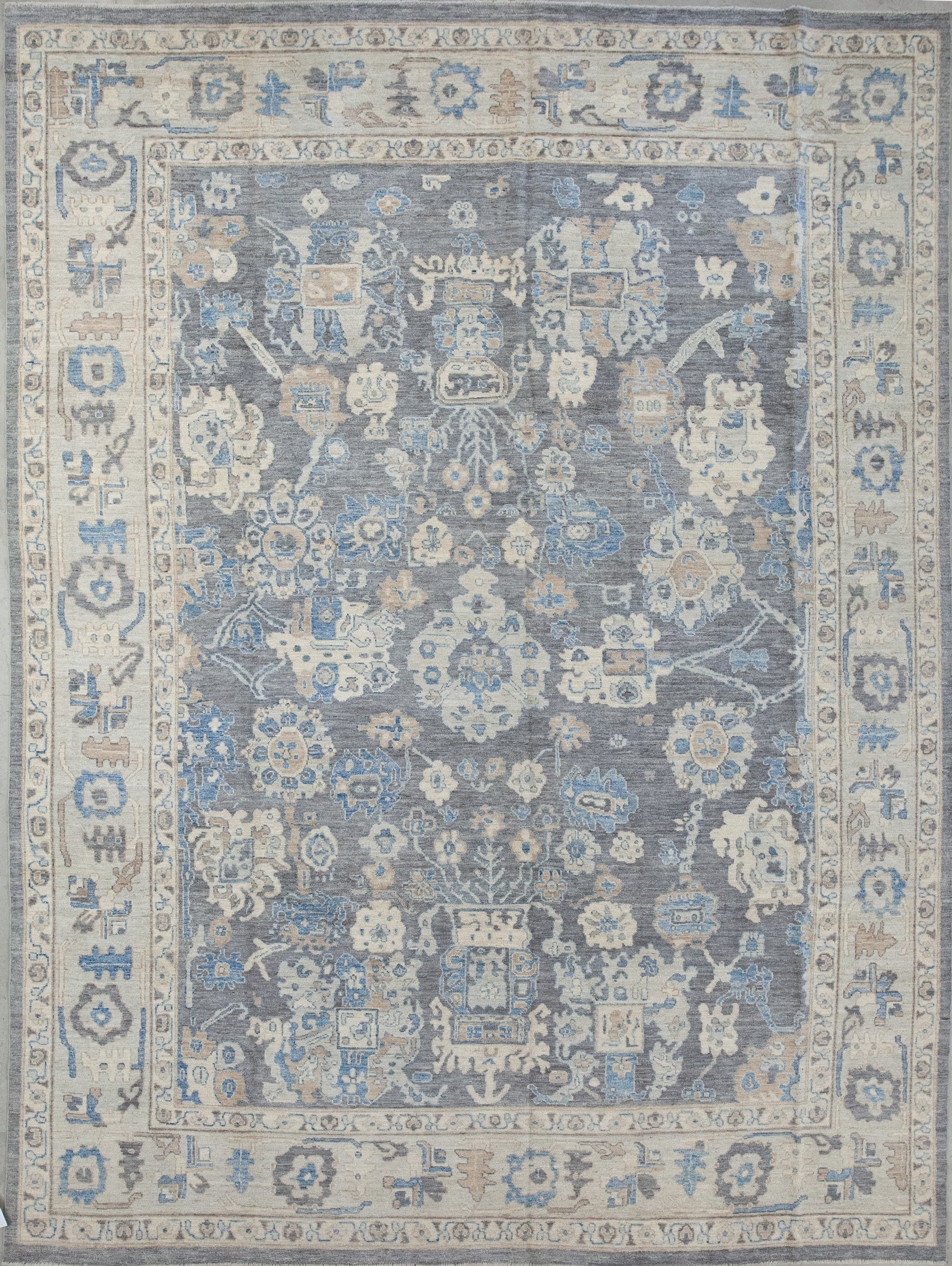 Classic rug comes with a sober color scheme which has gray, brownish, beige, and blue accents. The design renders abstract corals, flowers, and shields. 