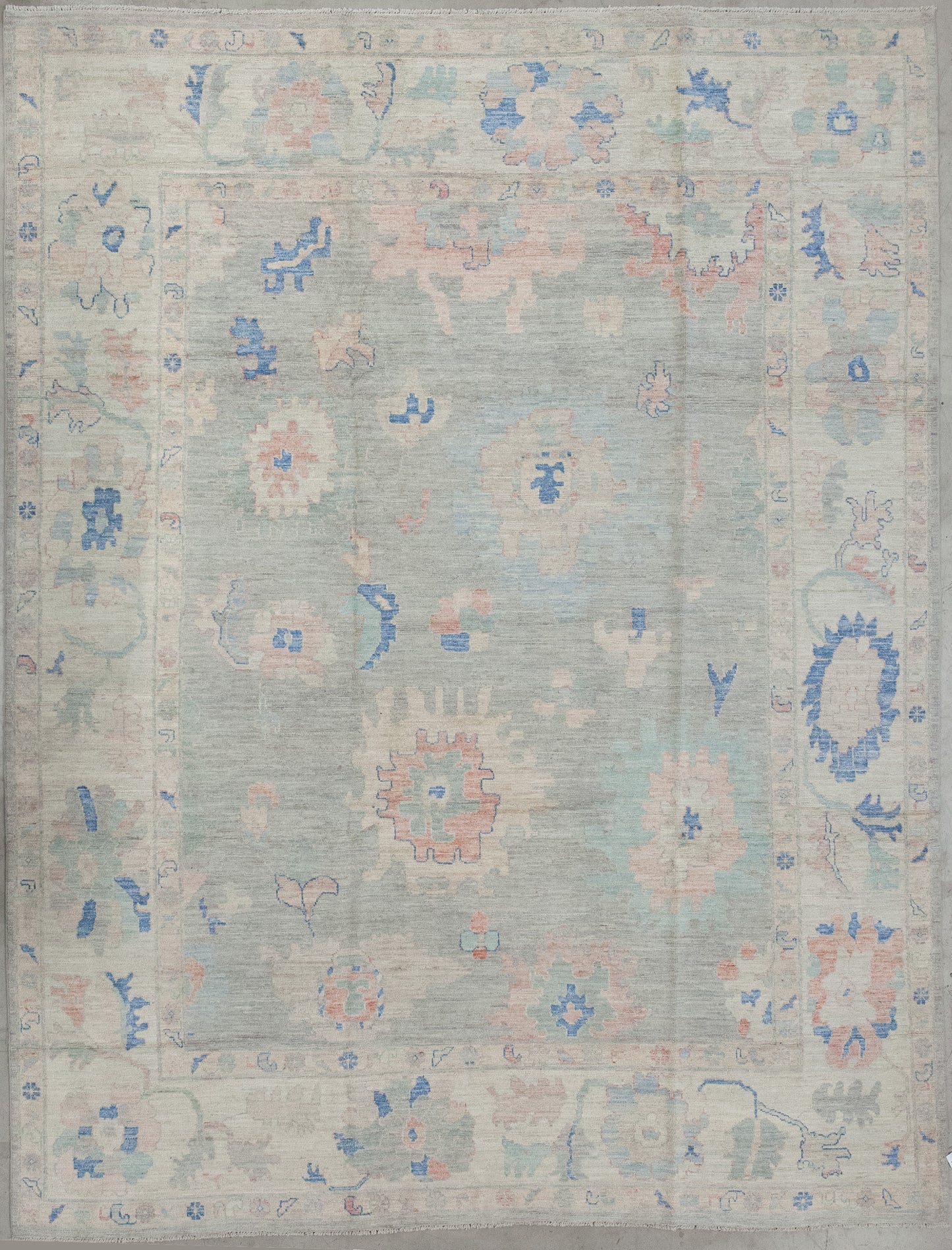Classy rug woven with a green mint background and a dianthuses flowers' abstraction on top. Also, the color scheme comes with beige, blue, and pinkish tones for the contrast.