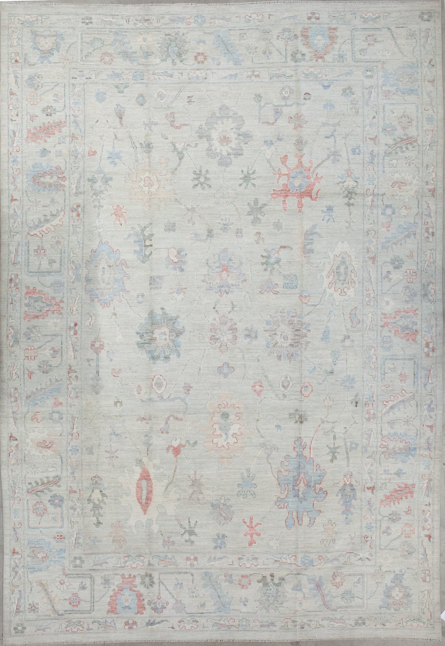 The elegant rug was woven with gray as the dominant color. On top of the rug, there is a design which renders abstract sunflowers, thin branches, paint splatters, and long leaves.