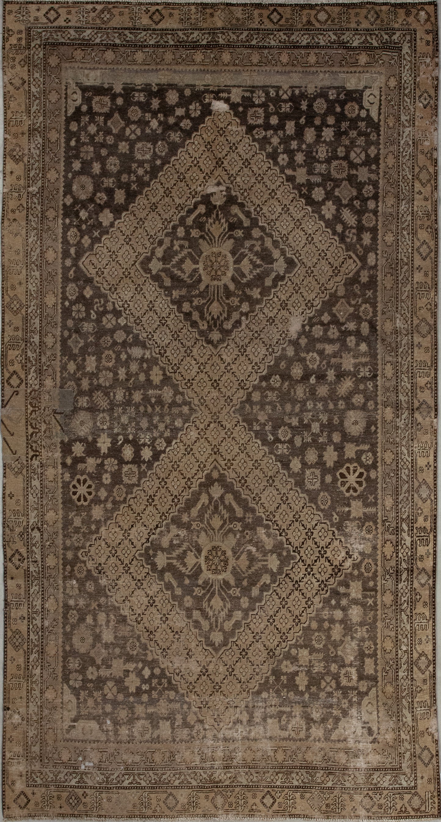 The simplicity of this carpet makes it a great asset for your home because the color scheme oscillates among variations of brown. The design features two huge rhombuses which have tiny flowers as a pattern in the contour holding mandalas in the center.