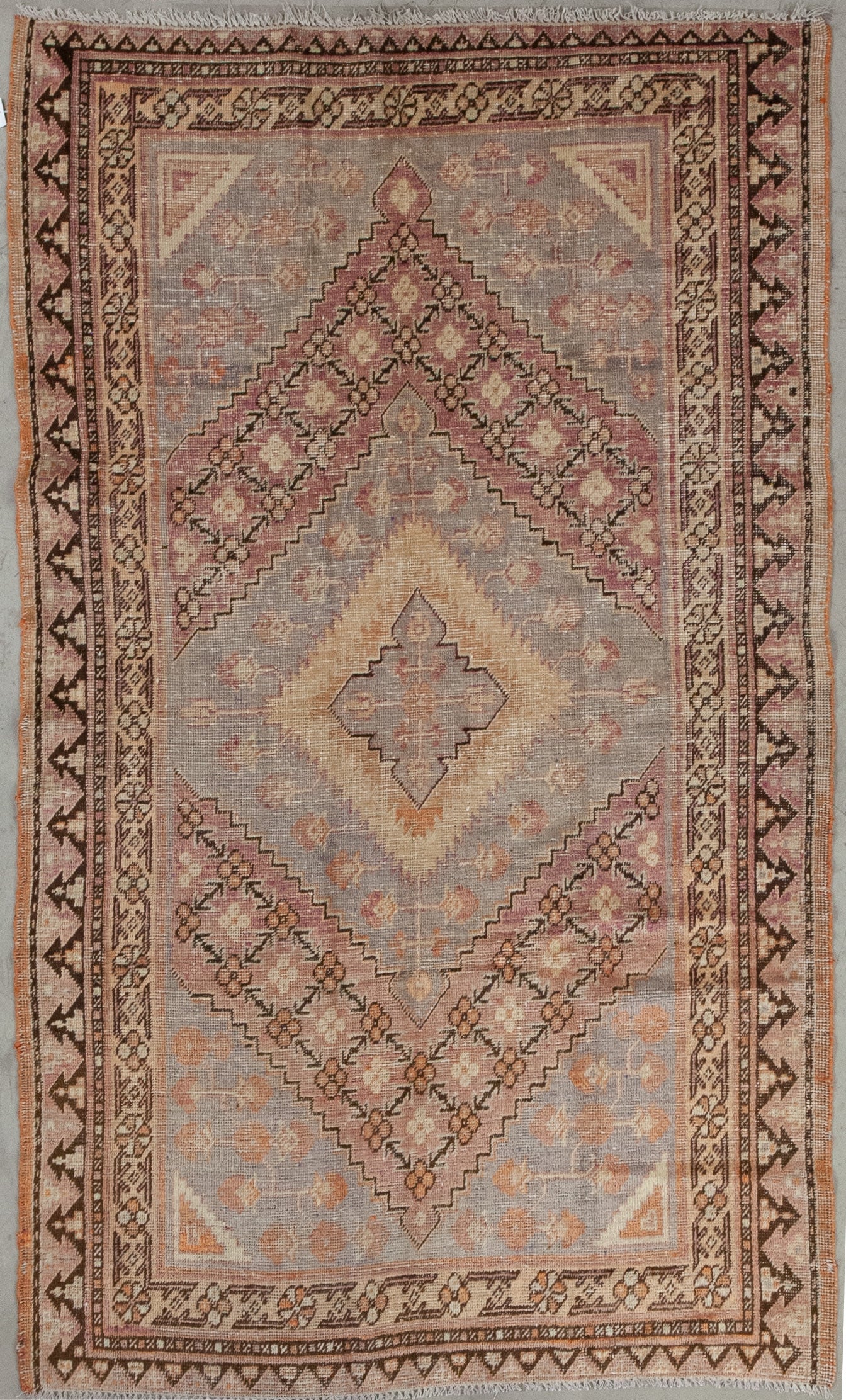 This decorous rug was woven with a solid color scheme which has brown as the dominant tone, black, burgundy, beige, and gray. The design features rhombuses' shapes mainly.