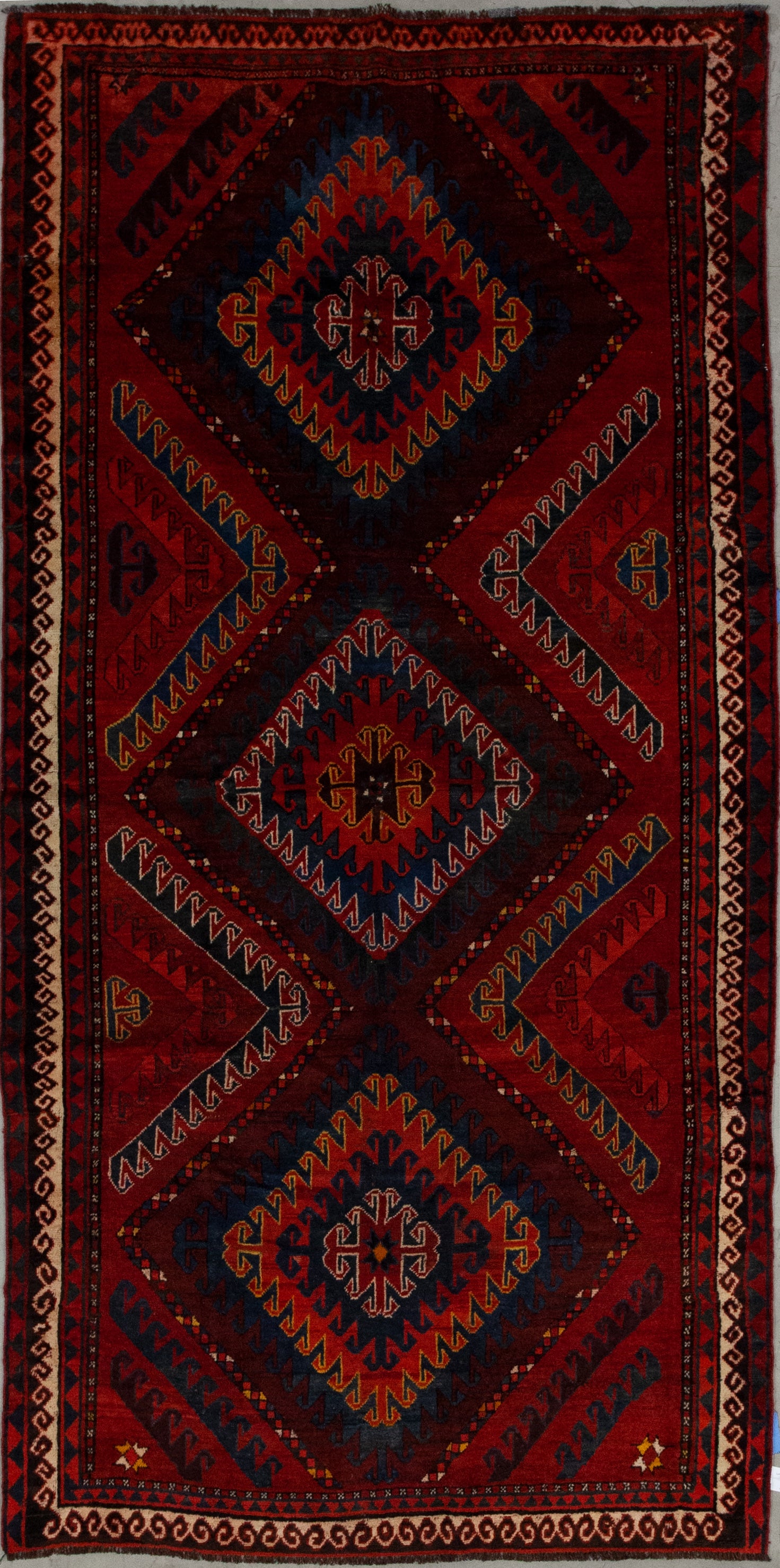 This powerful carpet comes with an intense and vibrating color scheme which has variations of red as the dominant tone plus orange, blue, yellow, brown, and white. 