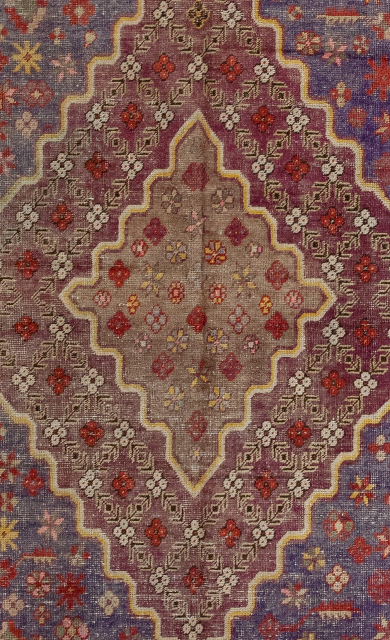 The rug's close-up displays the large burgundy background of the rhomb, and the brown background of the nested one.