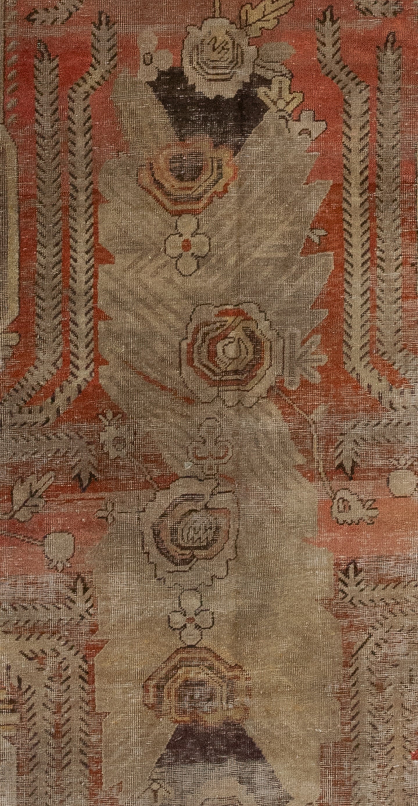 The center of the rug features a large roses' bouquet and its reflection on the bottom creating a radial symmetry.  