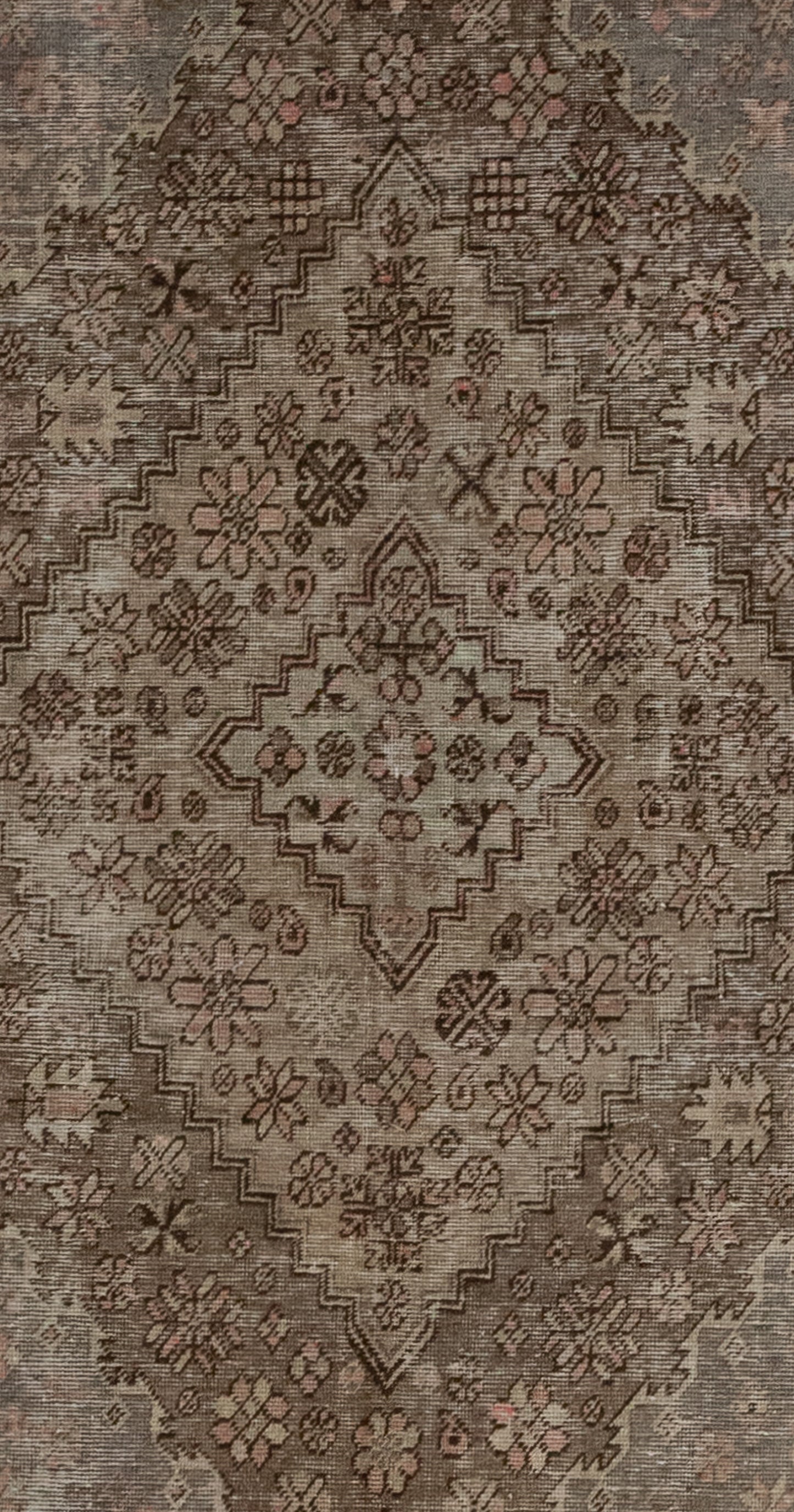 The center of the rug features a large rhomb with more nested rhombuses which are patterned with abstract types of flowers.