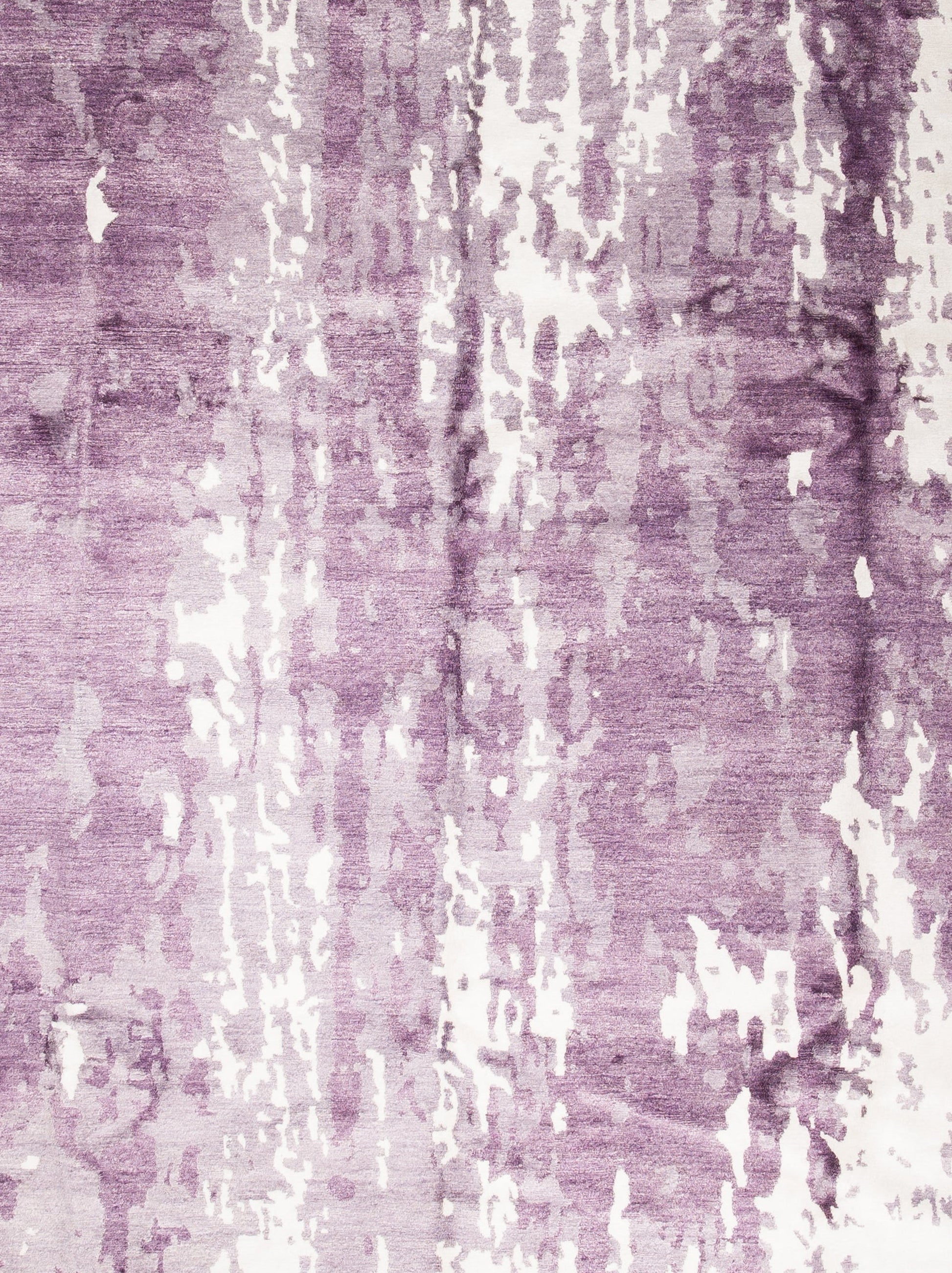 the close up of the center shows how beautiful the purple color scheme is knotted in this rug.