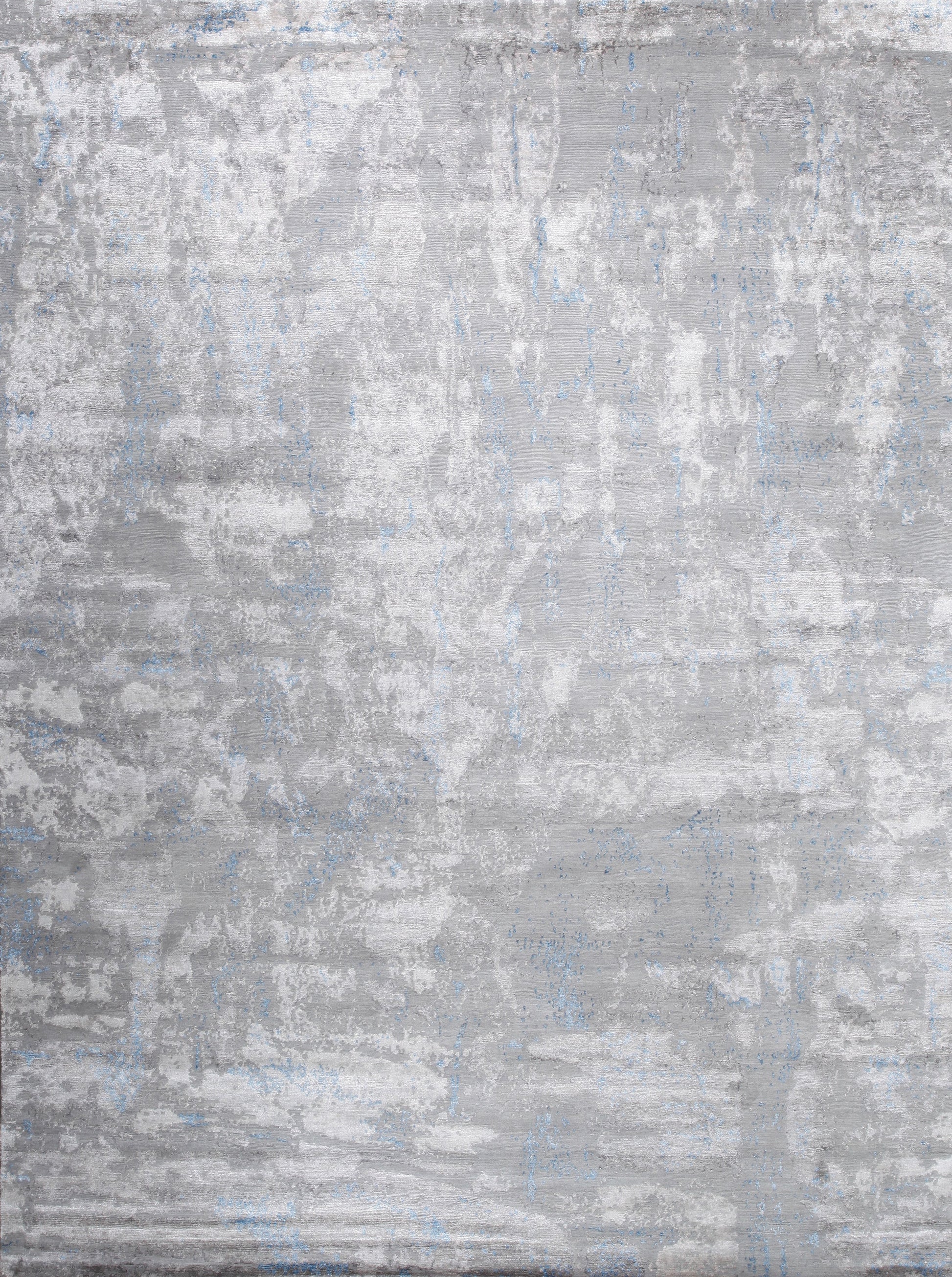 Modern rug in grayscale with blue accents.