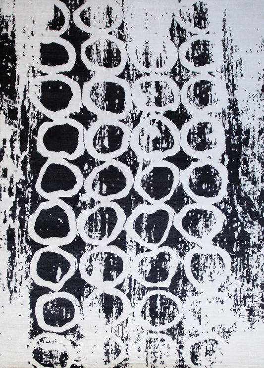 Black modern rug with intense white rings pattern.