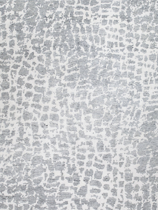 The color scheme is white and light gray; also this stylish carpet renders an animal print design.