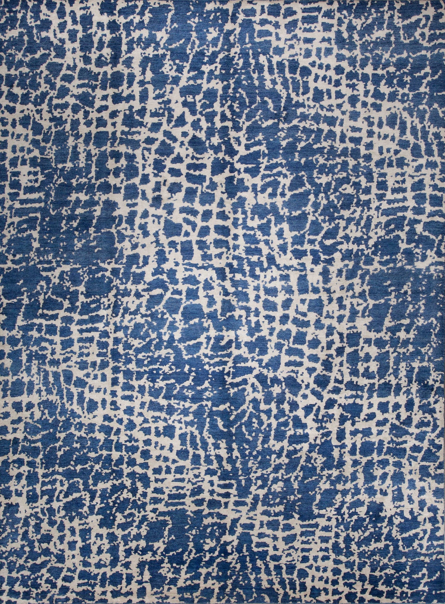 Animal print rug knotted with blue and silver.