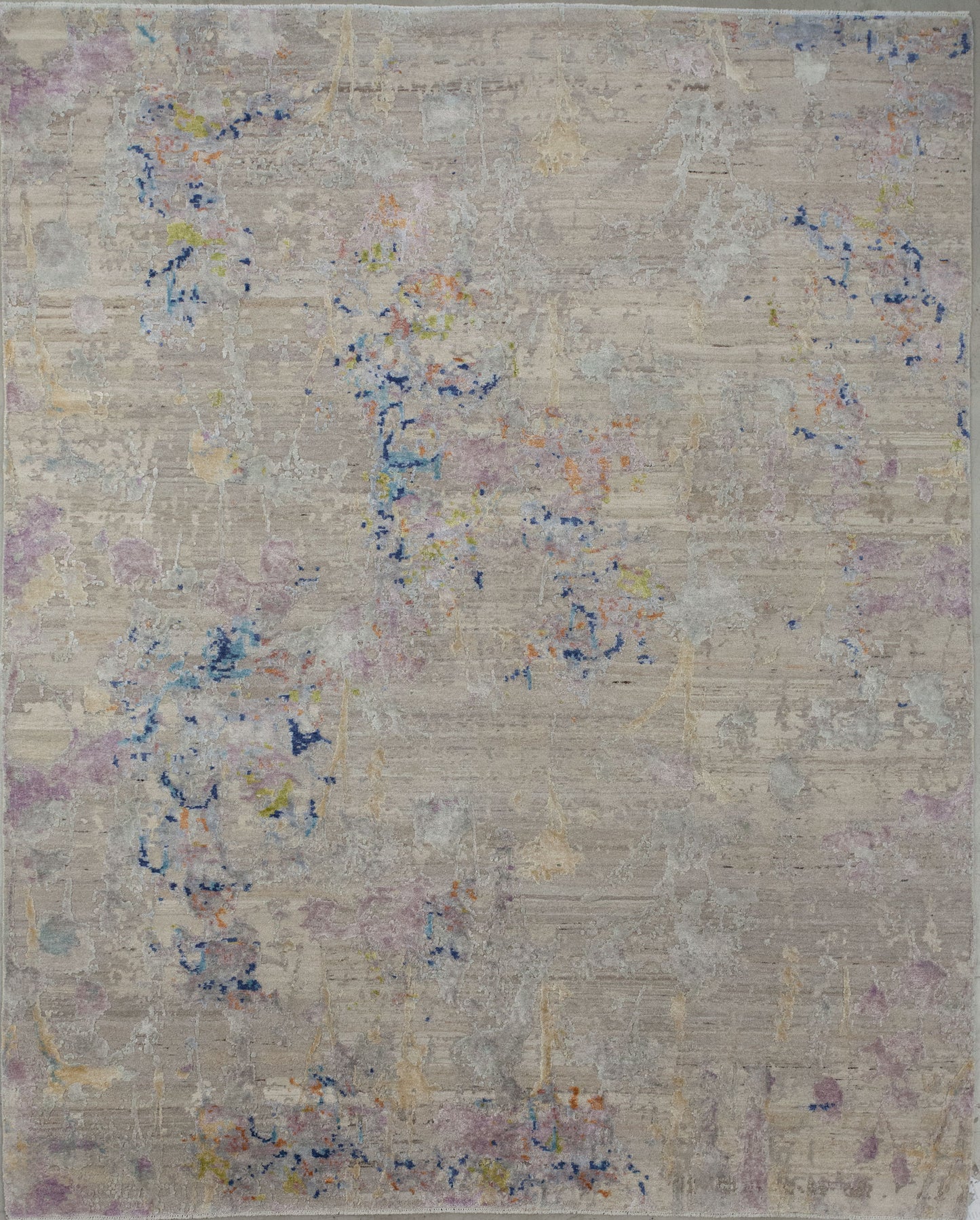 Contemporary rug wove with beige background and a multicolor abstract design.