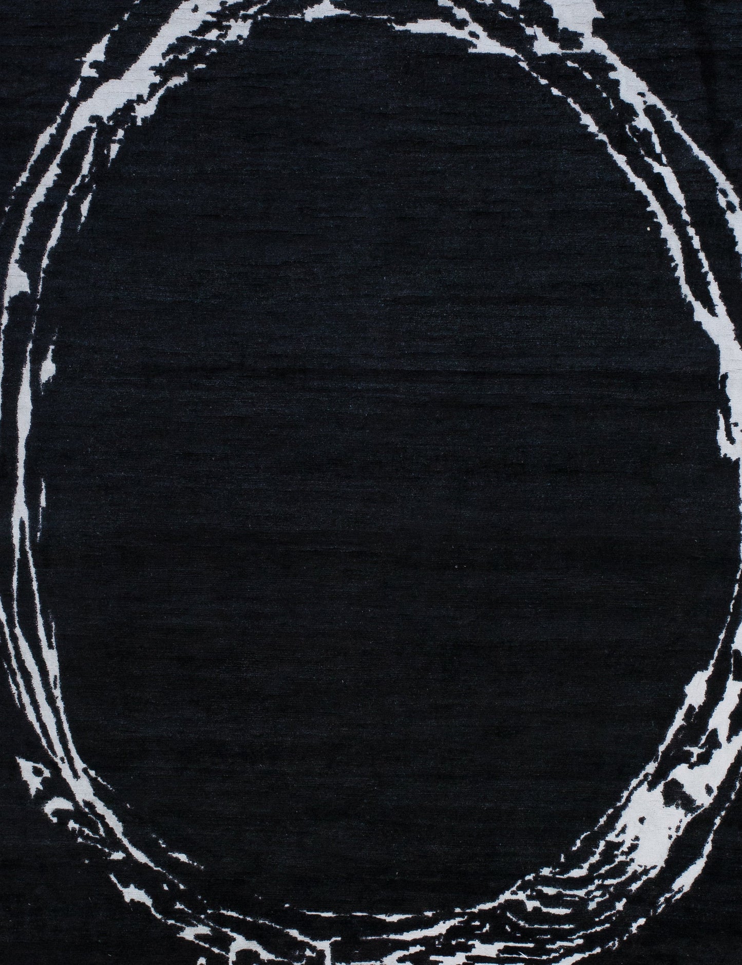 the center of the rug is black with the white ring enclosing it.