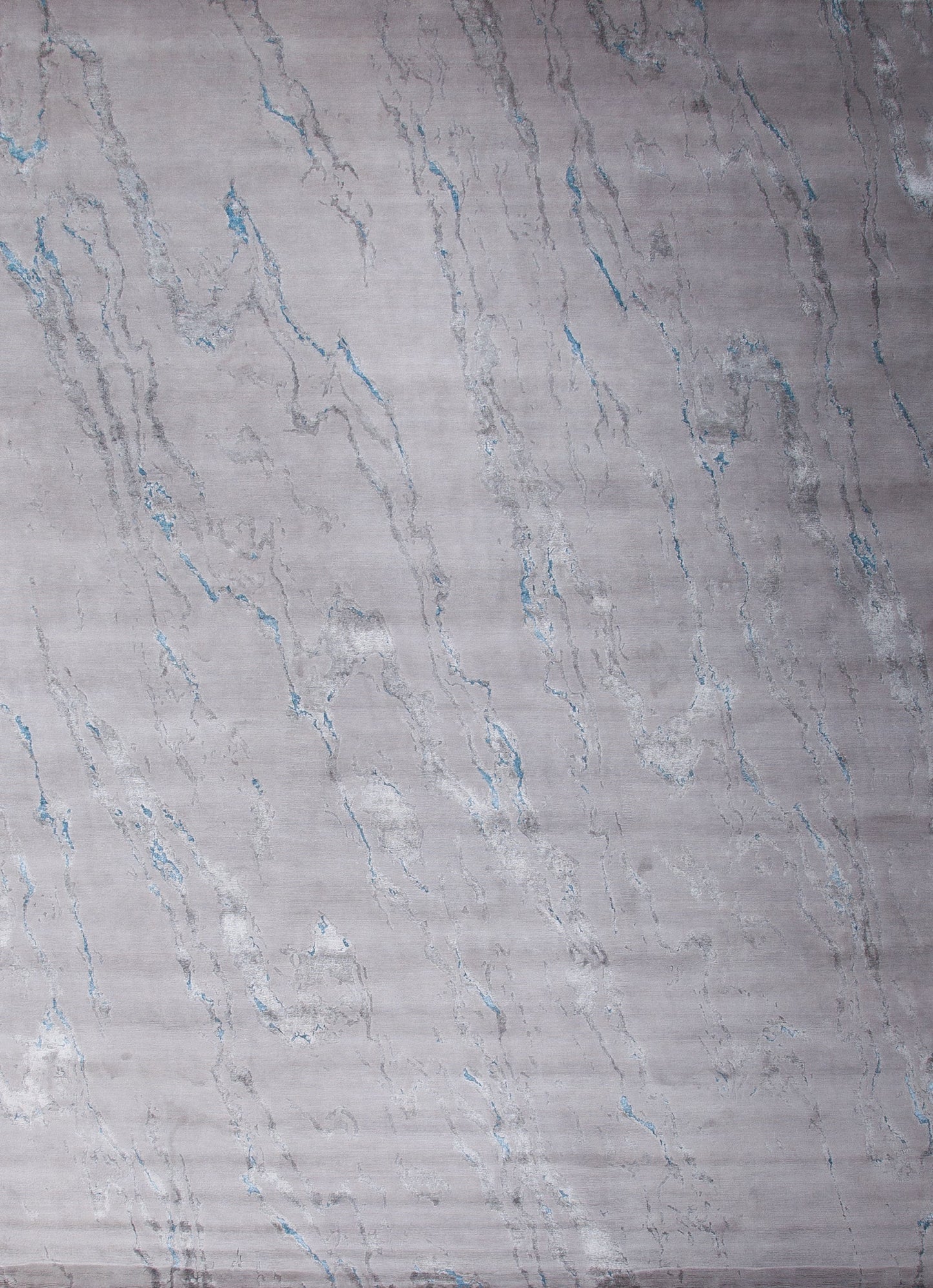 Contemporary rug with a marble design in blue and white.