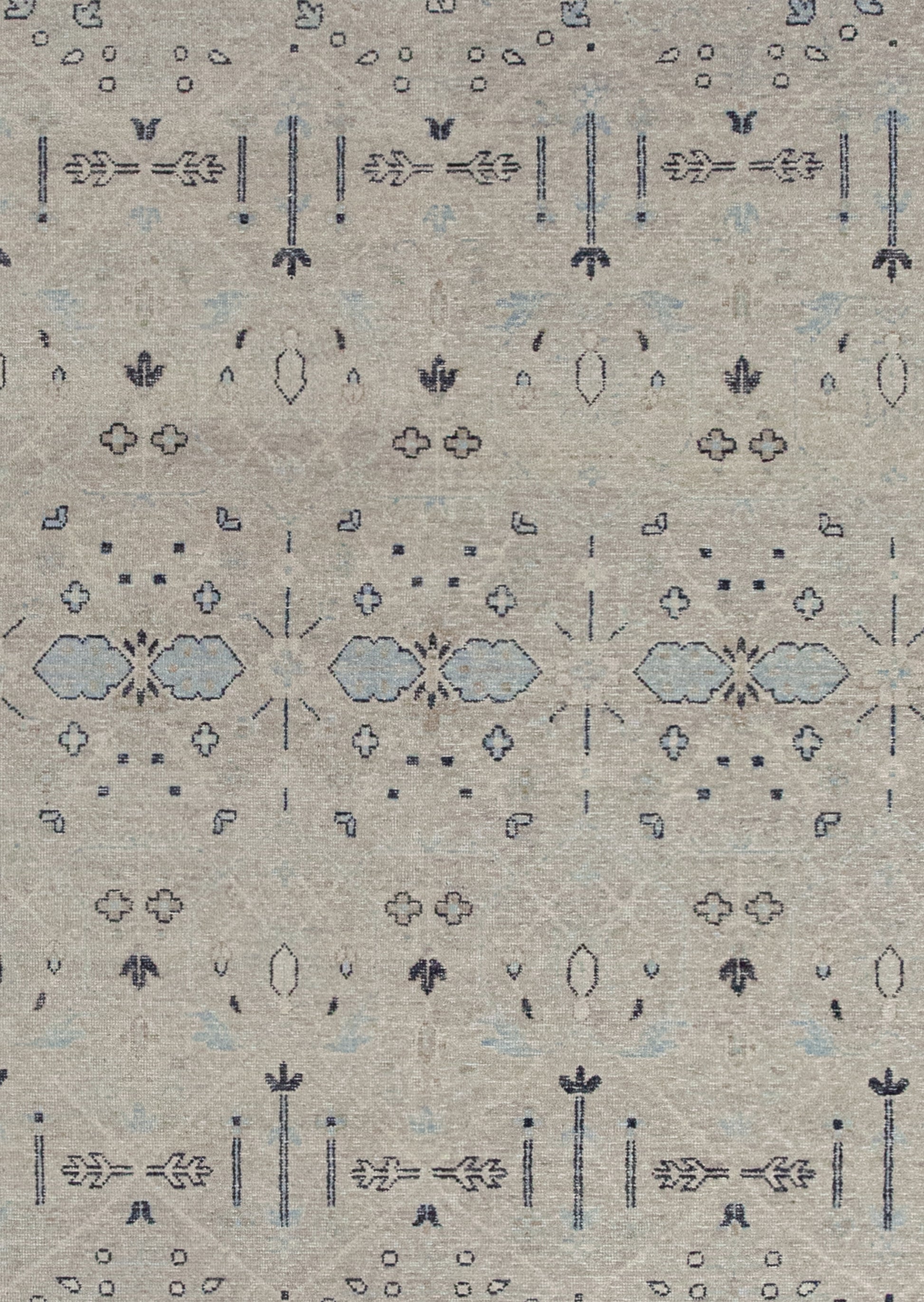 The rug's background is beige with the black outlined composition and blue details on top.